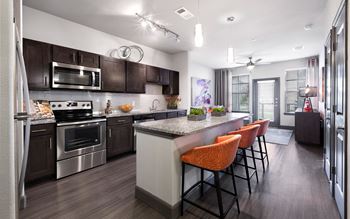 Fitted Kitchen With Island Dining at North Creek Apartments, Texas